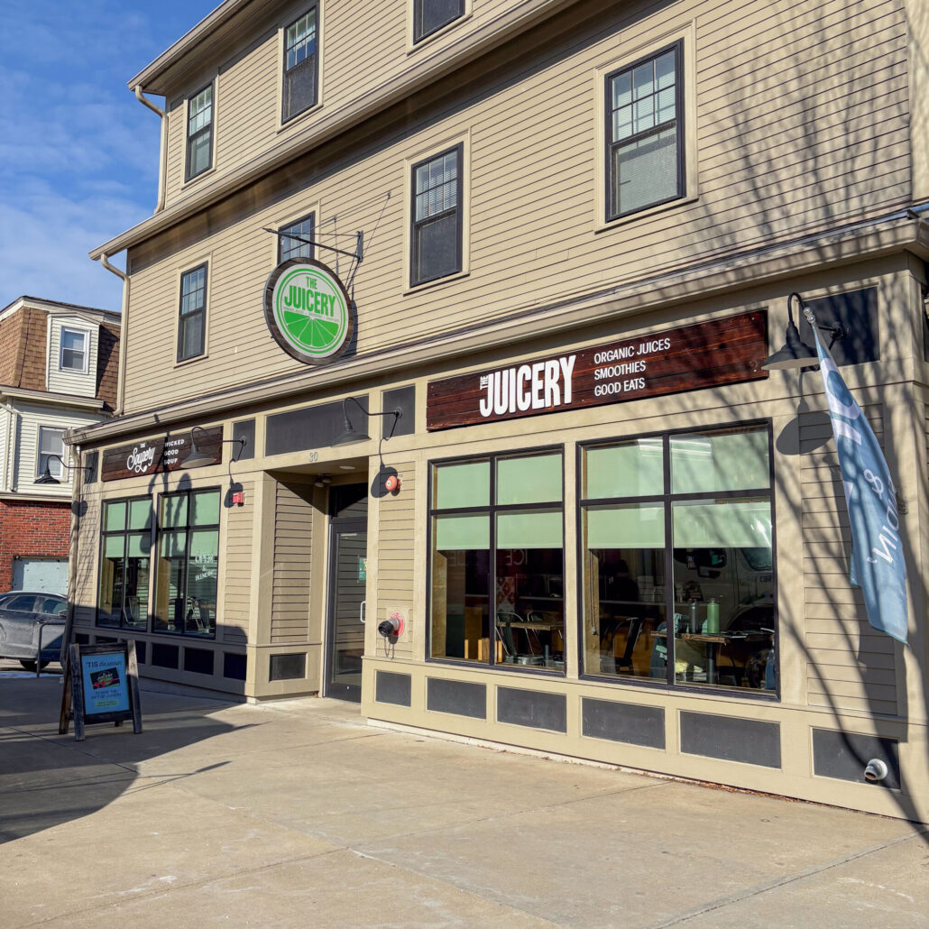 Exterior of The Juicery’s Durham (UNH) location with large front windows and Juicery signage.