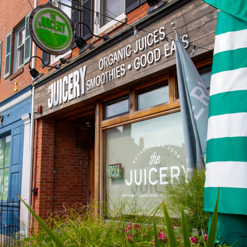 Exterior of The Juicery’s Newburyport location with branded signage and street-level storefront.