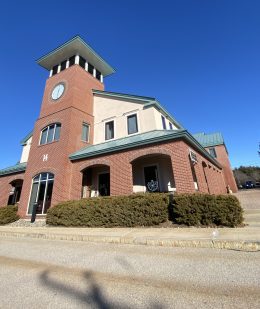 Exterior of The Juicery’s Pease Tradeport location inside a brick building with a clock tower.